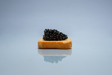 Black caviar. Sturgeon caviar. Fish delicacy. Canape with caviar. Expensive snack. Buffet platter. Products for immunity. Food rich in iodine. Exquisite dish.