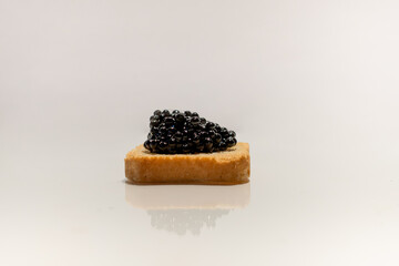 Black caviar. Sturgeon caviar. Fish delicacy. Canape with caviar. Expensive snack. Buffet platter. Products for immunity. Food rich in iodine. Exquisite dish.