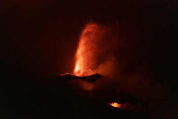 Volcano spitting lava into the night's sky on La Palma, Spain