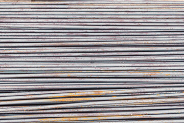 Close up steel rebar for building texture in the construction site. Rebar is an important building material. Rusty iron bars at the construction site. Steel bars with a rusty close-up background.