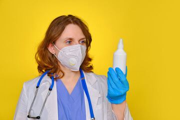 Doctor with a bottle of medicine in his hand, studio background copy space