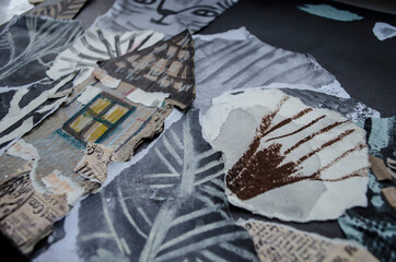 Graphic texture of charcoal sangina watercolor ink collage on a black background.