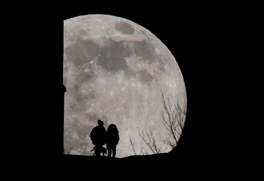 Full moon rises as viewed from Glastonbury Tor, in Glastonbury