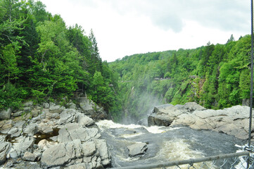 Above the waterfalls cliff edge with water falling between rocks during spring