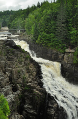 Sideview of waterfalls running down the rocks and trees
