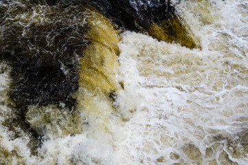 Water flowing from a waterfall crashing between the rocks