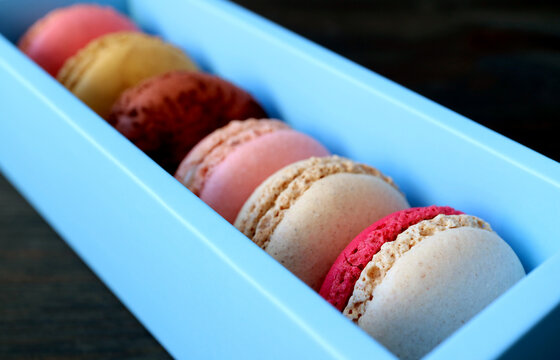 Closeup Assortment Of Gorgeous Colored Macaron Pastries In A Light Blue Box