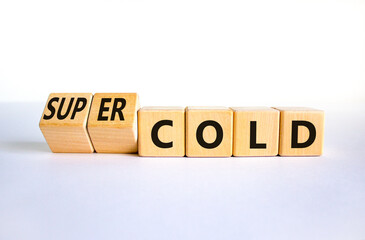 Super cold symbol. Turned wooden cubes and changed concept words cold to super cold. Beautiful white table, white background, copy space. Medical and super cold concept.