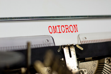 Covid-19 corona and omicron symbol. The concept word Omicron typed on retro typewriter. Beautiful white background. Medical covid-19 corona omicron concept. Copy space.