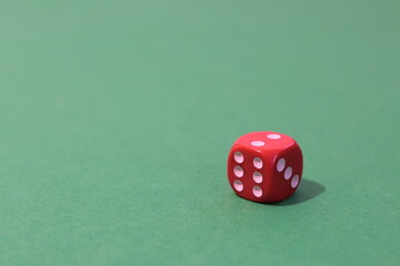 Minimalist photo of a red dice on a table
