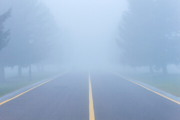 Foggy rainy highway road, low poor visibility, accident danger warning.