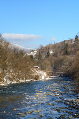 water flowing over rocks and ice in mountain river