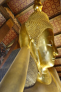 Head of world famous Reclining Buddha statue at Wat Pho temple (vertical image), Bangkok Thailand