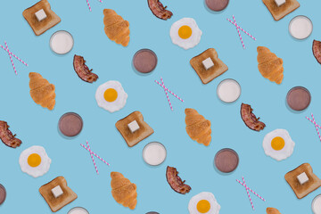 Creative pattern made with fried eggs, slices of crispy bacon, toast bread, croissant and glasses of milk on blue background.