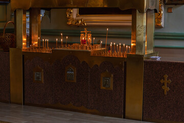 Orthodox Church. Christianity. Festive interior decoration with burning candles and icon in traditional Orthodox Church on Easter Eve or Christmas. Religion faith pray symbol