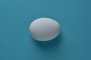 Fototapeta na wymiar natural white eggs on a blue and yellow background