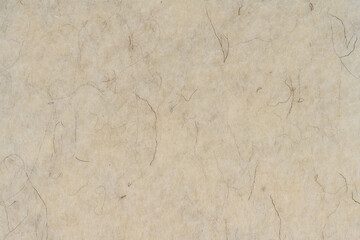 Light beige matte background of suede fabric, closeup. Velvet texture of seamless cream textile,...