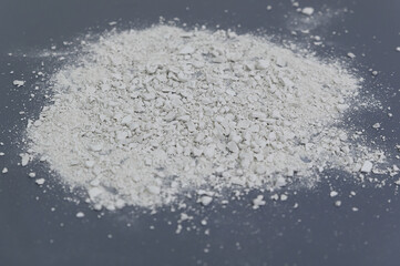 destroyed white stone to a fine fraction on a gray background.