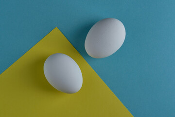natural white eggs on a blue and yellow background