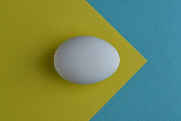 natural white eggs on a blue and yellow background