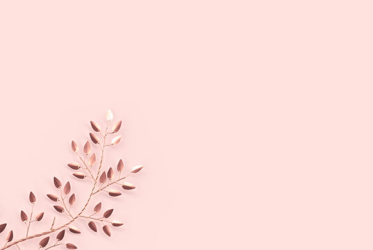 Elegant and minimalist style 3D rendering of golden branches and leaves on rose gold background