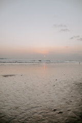 A relaxing scene of a secluded and peaceful beach setup, hammock, lounge area and beach huts on a paradise tropical island at sunset in South East Asia, Komodo Islands, indonesia