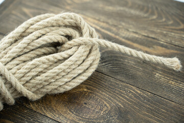 Fototapeta na wymiar linen rope on a wooden background in