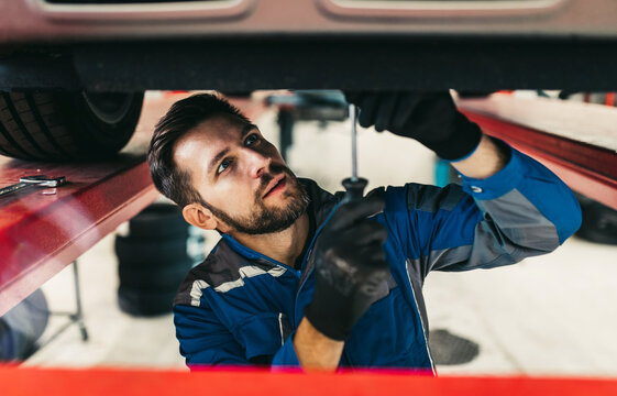 A professional mechanic working in a car service.