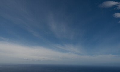 Naklejka na ściany i meble view of the atlantic ocean, from prazeres portugal, madeira, blue sky and clouds