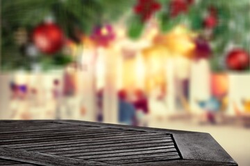 Wooden table with bokeh Christmas background of abstract in front of coffee shop or restaurant or montage.