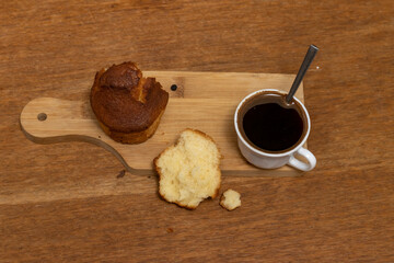 White cup of coffee and muffin on the table