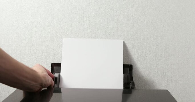 office worker loading paper into printer