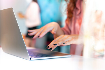 Young businesswoman sitting in the office working on a laptop computer