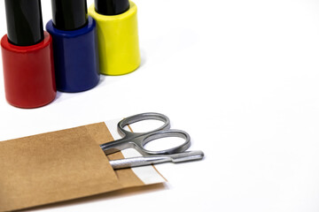 Manicure or pedicure background with nail polish bottles and sterilized metal tools for manicure...