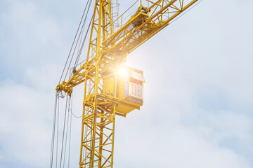 yellow crane on a white sky background.Technology equipment for transportation for bring construction materials to over or high construction site.