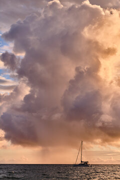 A catamaran is anchored off of Kamaole Beach during sunset in Kihea.