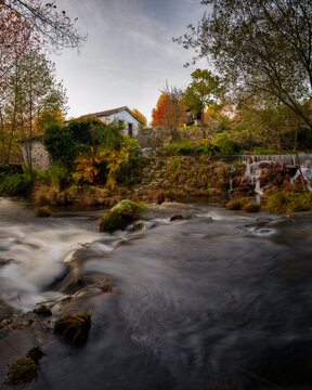 Mondim de Basto waterfall with a mill house at sunset in Portugal
