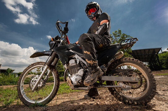 man posing on his dirt bike on race track in Bangkok