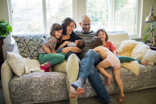 Fun family of six sitting at home on the couch.