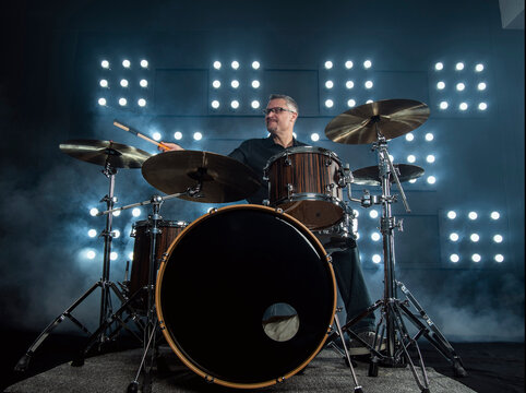 drummer performing in front of audience blinder