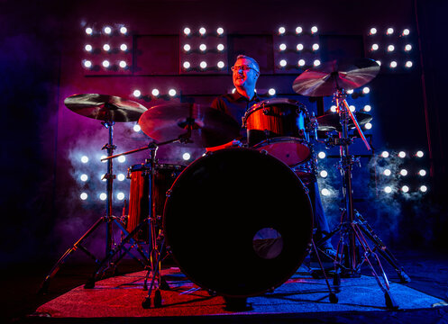 drummer performing in front of audience blinder