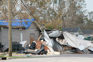 close up of homes destroyed and power lines down after a hurricane. 