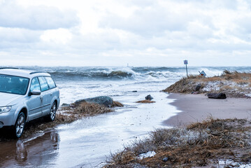 Stormy weather by the sea in Riga, Latvia. Huge waves crashing down the coast of Latvia. - obrazy, fototapety, plakaty