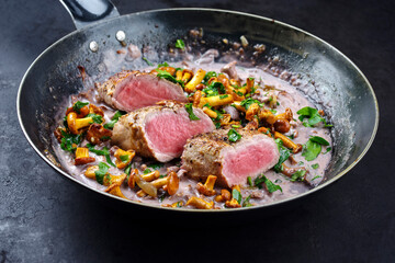 Fried dry aged pork fillet chateaubriand medallion steak natural with chanterelles in walnut cream...