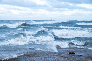 Stormy weather by the sea in Riga, Latvia. Huge waves crashing down the coast of Latvia.