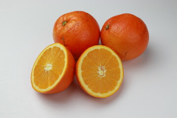 Fresh oranges on a white background. Close-up