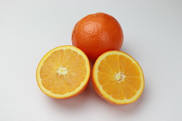 Fresh oranges on a white background. Close-up