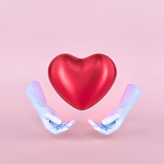 Valentine creative concept of giving and sharing love red heart with hands. Pastel pink background.