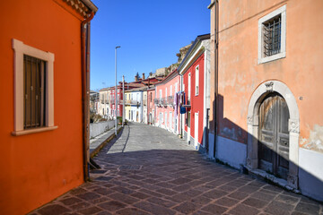 Fototapeta premium A street among the characteristic houses of Montecalvo Irpino, a village in the mountains in the province of Avellino, Italy.
