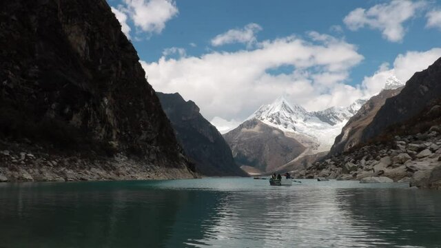 Boat paddles in the mountain lake Paron with its turquoise waters in the high Andes of Peru